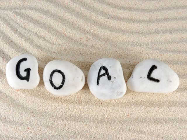 Cyber Aliens developer working on a laptop with creative icons, illustrating the expertise of the best web development company in Alappuzha.